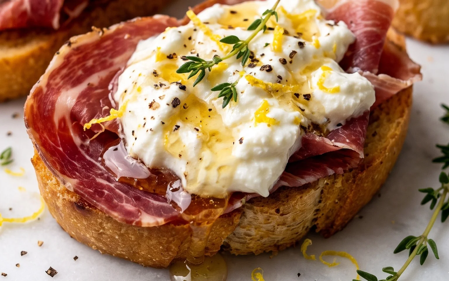 Beef Prosciutto Crostini with Burrata and Lemon Honey Drizzle