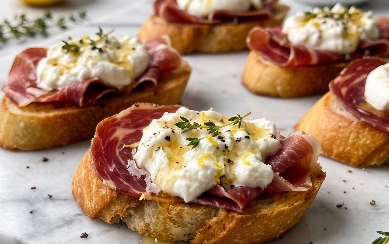 Beef Prosciutto Crostini with Burrata and Lemon Honey Drizzle